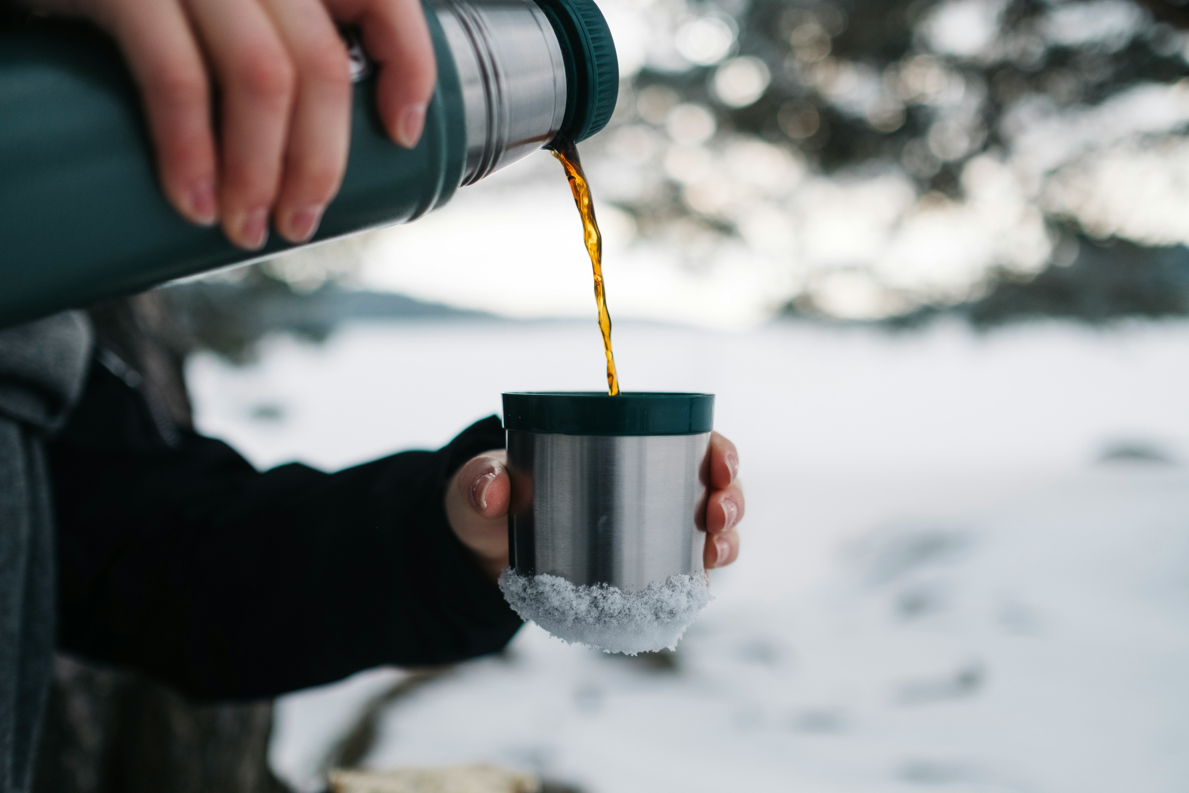 person pouring a mug